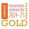 An orange and gold logo. Text reads: Devon tourism awards 2024-25 Gold